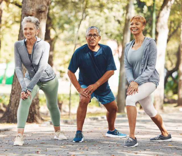 group of people exercising in a park